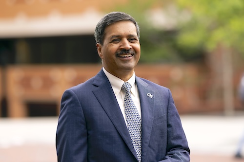 A formal photo of Georgia Tech Dean of Computing Vivek Sarkar outside