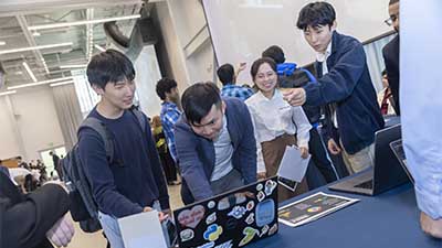 Students participate in app demonstration at the CS Capstone Expo. Photo by Terence Rushin. Top photo: First year students meet for intro CS class. Photo by Kevin Beasley.