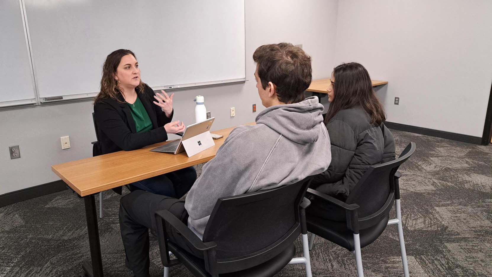 Whitlow mentors a student group on their startup for the course.