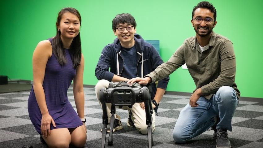Three students with a spot robot