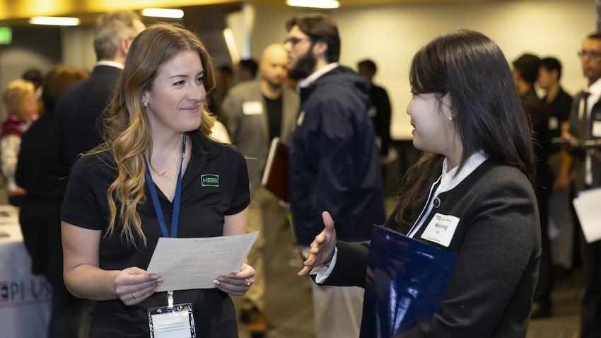 Georgia Tech CS major shares her resume with industry rep at career fair