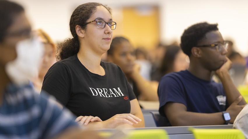 A Georgia Tech CS major and her peers listen intently during a lecture