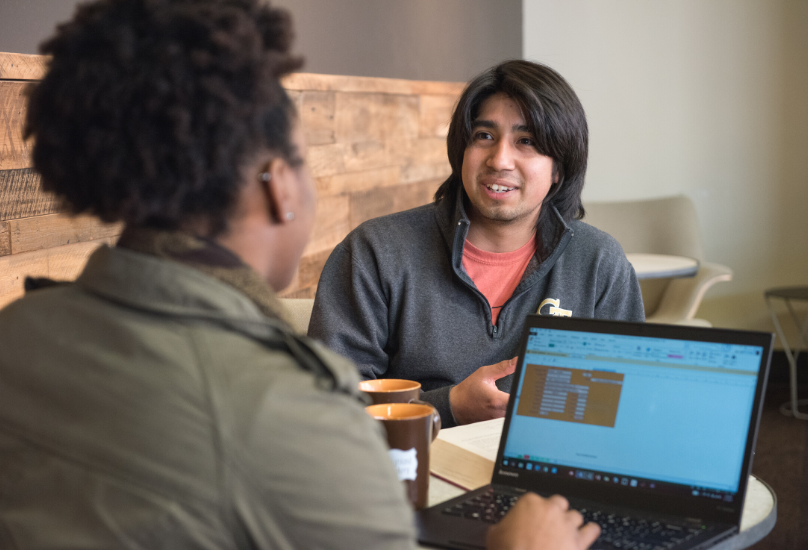 students talking at a table