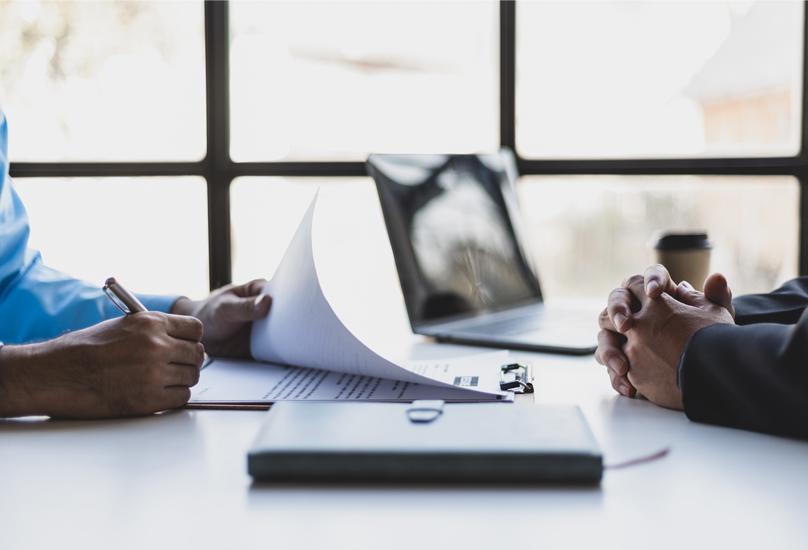 Hands on a desk at a job interview